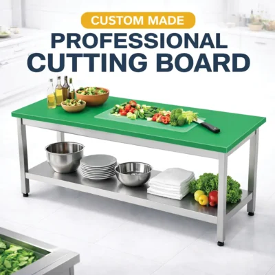 Green polyethylene cutting board with stainless steel table for commercial kitchen food preparation.