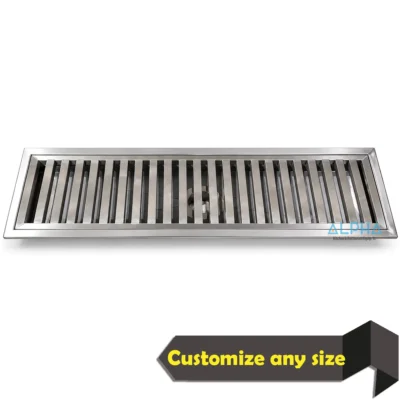 Stainless steel floor trough drain with removable bar grating and central outlet for commercial kitchens.